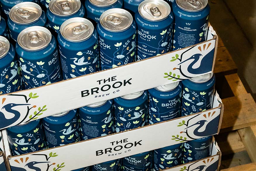 Cases of The Brook's From the Lake beer cans stacked.