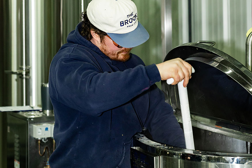 The Brook's head brewer mixing ingredients in the brewery.
